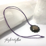 Pendant Necklace- antique gold background with dark purple glitter resin with glass dome finish