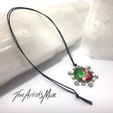SOLD Snowflake Pendant Necklace- hand designed red and green with glass dome finish